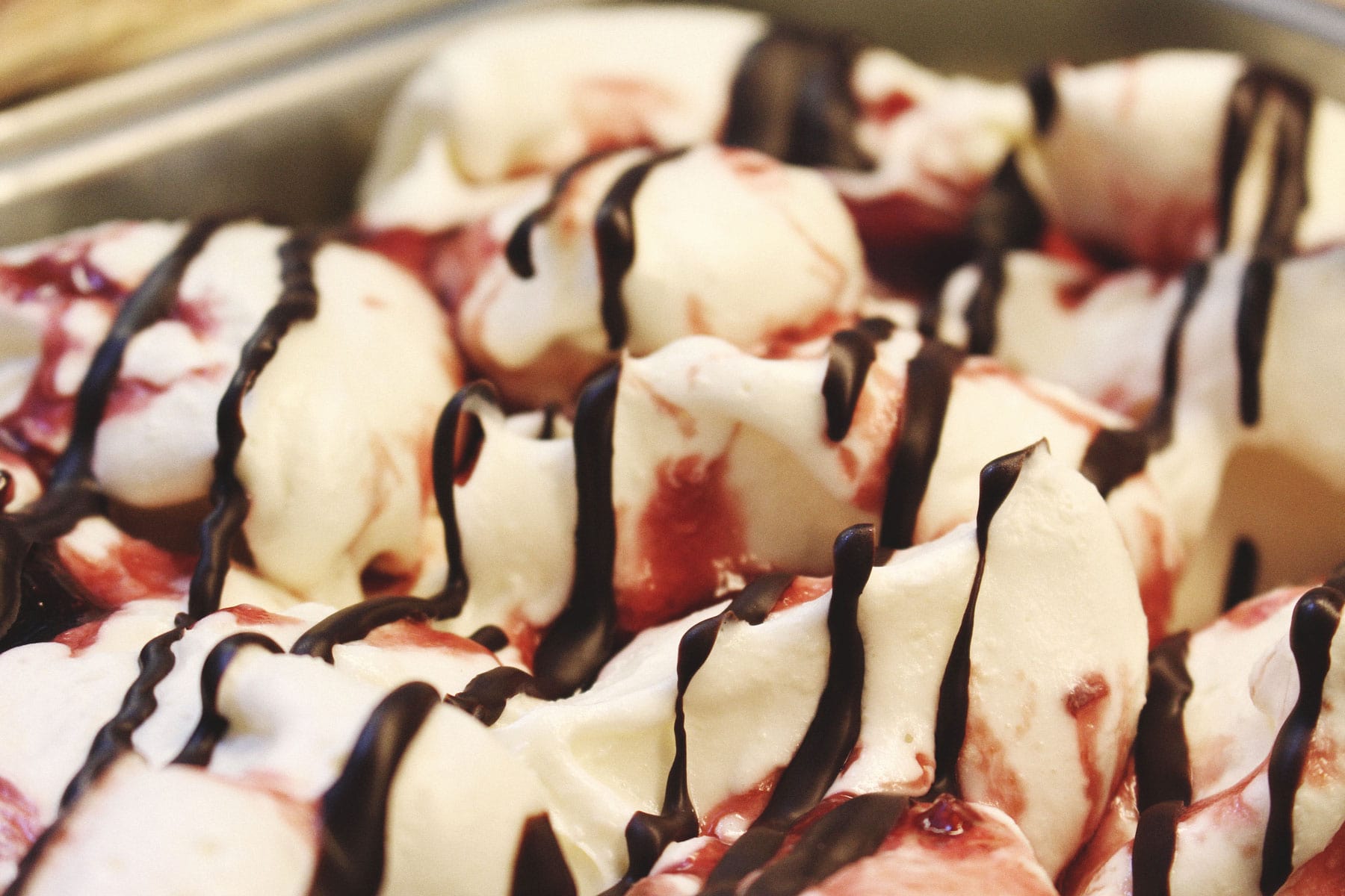 cherry cheesecake gelato with chocolate drizzle