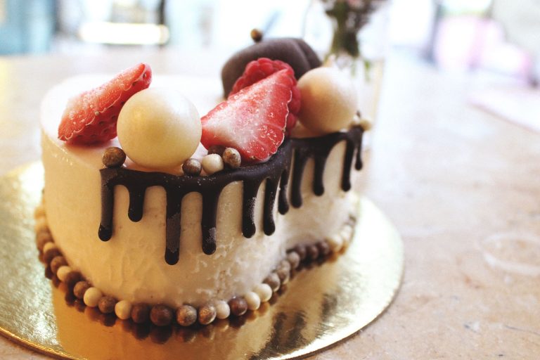 gelato cake with berries and chocolate drizzle